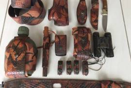 Custom Made Hunting Leather, Hand Tooled, Hand Stiched 13 piece Camo finished Hunting Leather. Covers all shooting disciplines from Pidgeon/Bird shooting to Impala/Kudu. Includes Water Bottle and holder, Bushnell camo 10 x 50 Binoculars, Leupold commorative Knife (Rare only 1500 made),
Rifle sling with swivels.
Holster is small frame Glock. 