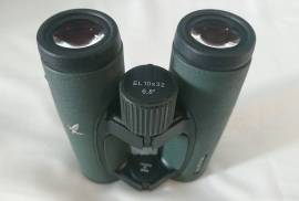 Swarovski EL 10X32 SV !!, BRAND NEW, never used, the most successful modern binoculars of Swarovski: The legendary EL 10X32. Late production so, yes, SWAROVISION (SV) coatings which offer breathtaking views and insane clarity! Field flattener lenses. Superb performance at any light condition. At just over 500gr., they are a pleasure to carry all day long! Stunning Safari GREEN colour. They come in original box, with papers, lens protectors, strap, cleaning cloth, sticker and a deluxe, rigid field bag for total protection of these valuable optics. BONUS SV Camera Adapter included! No longer available in 100% new condition! Made in AUSTRIA.
