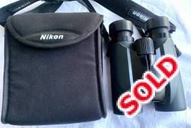Nikon Sporter 8x42 EX Binoculars with pouch., Waterproof (up to 1 m for 10 minutes) and fog-proof with O-ring seals and nitrogen gas for added resistance to the elements. Close-focusing distance of only 5 m. Turn-and-slide rubber eyecups with multi-click system make it easy to position your eye at the correct eyepoint. Eco-glass optics, free of lead and arsenic, are used for all lenses and prisms.
Magnification: 8X
Effective Objective Diameter: 42mm
Field of View at 1,000m: 122m
Exit Pupil: 5.3mm
Brightness: 28.1
Eye Relief: 19.7mm
Close Focus Distance: 5.0m
Interpupillary Distance Adjustment: 56-72mm
Length: 154mm
Width: 131mm
Depth: 58mm
Weight: 670g
Waterproof: Yes

 