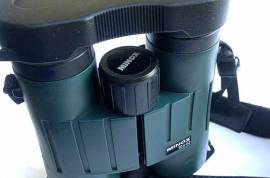 Minox Germany made Binoculars BV 8x42., Sometimes known as the MINOX BV 8x42 BR binoculars, the BV range of binoculars from quality German optic manufacturer MINOX. If you are looking for a quality pair of binoculars, these make an excellent choice.

These features include:

Multi-coated lens elements that reduce glare for brighter images with more neutral colours.
Phase correction that improves contrast and detail rendition even in poor light conditions.
Rubber eyecups that twist up and down to allow for comfortable viewing whether or not you wear eyeglasses.

Waterproofing means submersible to a depth of down to five meters in water or 0.5 bars. This means that they are sealed against the effects of dust, too.
Fog-proofing with nitrogen filling protects against corrosion and prevents fogging up of the optical surfaces as the temperature fluctuates from one extreme to another.
Rubber armour that provides an excellent grip in cold, wet weather and protects the binoculars from bumps.
