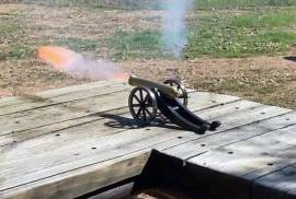 Black Powder Cannon , 36 cal. black powder cannon. Comes with powder measure. Full steel frame with thick brass barrel. 250 mm long, 110 mm wide, 85 mm high and weighs 1.5 kg. fun to shoot and actually rolls back on its wheels from the recoil or to have as a fancy desk ornament. Can not be fired in your back garden as it is a small calibre muzzle loader.
