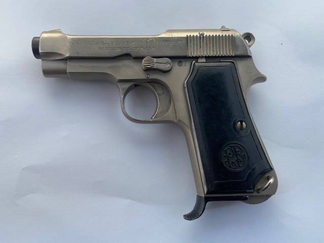 BERETTA MOD.34 9MM SHORT PISTOL (PLATED FINISH), Italian manufactured 9mm Short 7-shot single-action pistol. Plated finish with original grips, shows holster wear.



