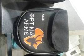 Optima Arms Earmuff Pouch, Locally manufactured from quality materials, these handy earmuff pouches will keep your ear protection safe, secure and easily accesable without the need to drape them around your neck. Available in the standard Optima branded format @R100 each or if you want something special you could have your or someone elses name printed on them, there are also a variety of colour options available. Please note that custom pouches are sold @R120+
depending on the materials requested and have a lead time of 3 working days.