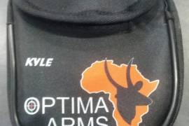 Optima Arms Earmuff Pouch, Locally manufactured from quality materials, these handy earmuff pouches will keep your ear protection safe, secure and easily accesable without the need to drape them around your neck. Available in the standard Optima branded format @R100 each or if you want something special you could have your or someone elses name printed on them, there are also a variety of colour options available. Please note that custom pouches are sold @R120+
depending on the materials requested and have a lead time of 3 working days.