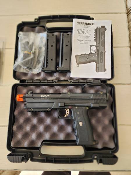 Tippmann TiPX + Olight, Tippmann TiPX paintball pistol with 2 magazines, spare CO2 cartidges, solid black and pepper balls. Never Fired.
Also, Olight PL-Mini2 600 Lumen, 100metre throw, fits to picatinny rail