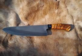 220mm Curly Birch Chef knife, 220mm Hand forged chef knife for sale. Blade is forged out of 52100 carbon steel with a Curly Birch handle, black G10 lines and bolster with brass pins.
Specs:
OA length: 330mm
Blade: 220mm 
Handle material: Curly Birch, G10 bolster and liner, brass pins.
Blade thickness: 5mm at heel, 2mm 1