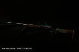 BENNIE LAUBSCHER .338 WIN, CUSTOM-BUILT .338 WINCHESTER BY BENNIE LAUBSCHER ON A WINCHESTER ACTION. THE RIFLE IS ENGRAVED AND COMES IN A LEATHER BOX.