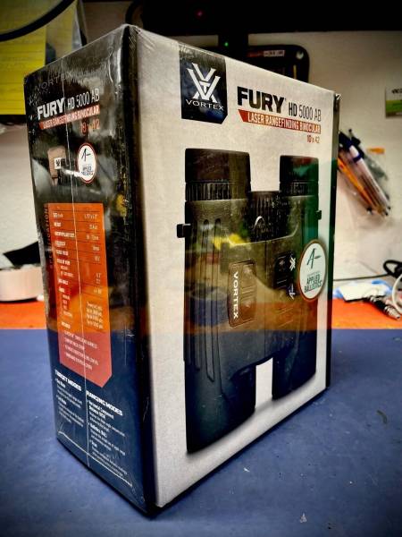 Vortex Fury HD 5000 AB 10x42 Laser Rangefinding , New, in box Vortex Fury HD 5000 AB Laser Rangefinding Binocular Equipped with Applied Ballistics, LRF302

Max Angle +/- 89 
Eye Relief: 16mm
Weight: 32.4 oz

Includes:
Glasspak Binocular Harness
Comfort Neck Strap
Tethered Objective Lens Covers
Rainguard Eyepiece Cover
Range:
Minimum: 5 yds
Deer: up to 1600 yds
Trees: up to 2400 yds
Reflective: up to 5000 yds
 
