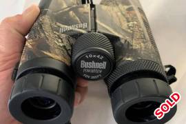 Bushnell Powerview Roof 10x42 Camouflage Binocular, Bushnell 10x42 Powerview Roof Prism Realtree AP Binoculars is ideal for long range observation. Its lightweight, stylish and rigid body design makes these binoculars extremely rugged. The large size objective lens of 42mm increases light transmission and offers viewing even in low light conditions. The multi-coated with anti-reflective properties assure the maximum light transmission and deliver bright, crisp images in the widest range of viewing conditions.

For long observation it can be mounted on tripod with the help of optional adapter. Its rubber armoured coated protect it from any damage, slip-resistant even wearing gloves during wet conditions. The long 17.5mm eye relief design offered viewer to see entire 98m field of view clearly and effortlessly even for with and without glasses users. This binocular is reliable, portable with Realtree AP camouflage pattern finishing. It had a carrying case to keep the binocular safe during long travelling without any worry. It is perfect for hunting, camping, hiking and all kind of outdoor activities.

Features: Bushnell Powerview Roof 10x42 Camouflage Binoculars
·  All-surface treated optics for better
·  Light transmission and increased brightness
·  Anti-slip rubber protection that absorbs shock and provides excellent grip
·  Compact and lightweight design
·  New Contemporary styling
Specification: Bushnell Powerview Roof 10x42 Camouflage Binoculars
·  Manufactured: Bushnell Binocular
·  Magnification: 10x
·  Diameter: 42 mm
·  Field of view: 98m @ 1000m
·  Minimum focusing distance : 7 m
·  Size: Standard
·  Focusing : Centre
·  Prism type: Roof
·  Prism glass: BK-7
·  Lens treatment : Multicoated
·  Output pupil: 4.2 mm
·  Eye relief: 14.7 mm
·  Eyecups: Twist-Up
·  Waterproof / Anti-fog: No
·  Adaptable to tripod: Yes
·  Colour: AP Cam
·  Weight: 670 g

 