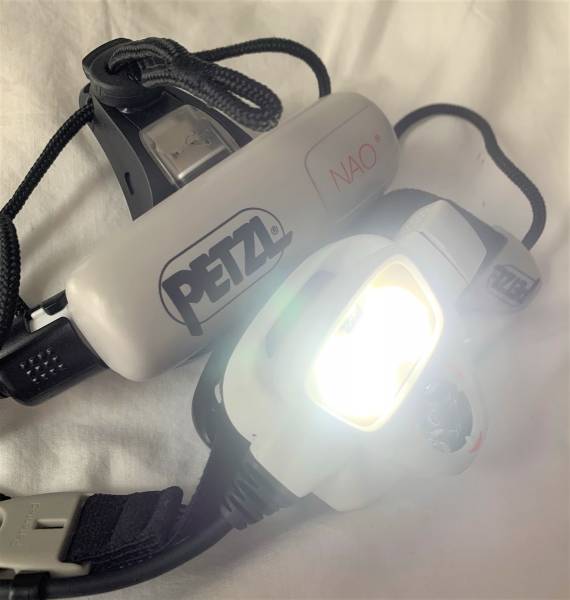 Petzl Nao headlamp, top-end rechargeable item from, The multi-beam Petzl Nao headlamp is powerful, rechargeable and automatically adapts light intensity to users needs.

Features:
Reactive Lighting technology ensures longer burn time, comfort and minimal handling
Light sensor adjusts brightness and beam pattern, thereby optimizing battery use
Wide beam for close lighting, focused beam for long range
Lock function prevents light turning on accidentally
Rechargeable 2600 mAh Lithium-Ion battery
Battery charge indicator
Very stable headband with top strap

Specifications:
700 Lumens
Weight: 185g
Recharge time: 6 hours
Watertightness: IP X4 (water resistant)
Certification: CE